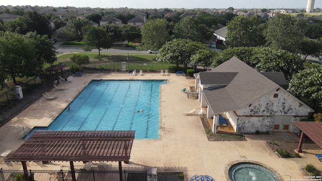 view of swimming pool featuring an in ground hot tub and a patio