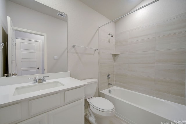 full bathroom with toilet, tiled shower / bath combo, and vanity