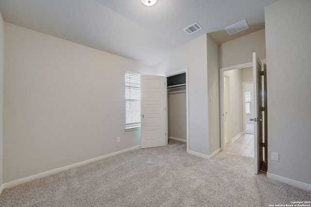 25776 Rosey Way, Boerne, TX 78006 - unfurnished bedroom featuring light colored carpet, vaulted ceiling, baseboards, and a closet