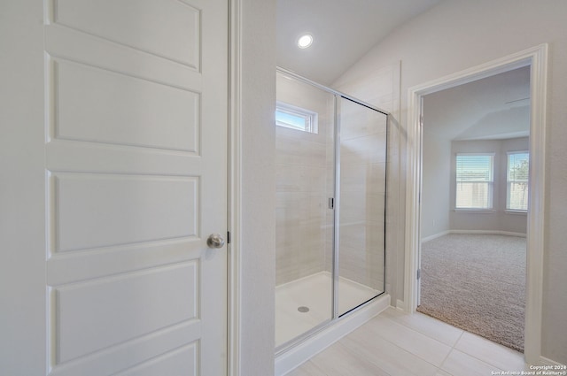 25776 Rosey Way, Boerne, TX 78006 - bathroom with a stall shower, plenty of natural light, tile patterned floors, vaulted ceiling, and baseboards