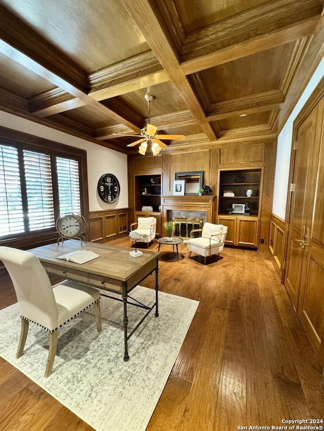 living room with crown molding, wood ceiling, hardwood / wood-style flooring, a high end fireplace, and built in shelves