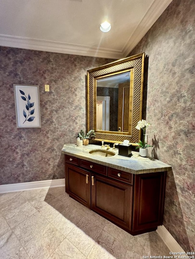 bathroom with ornamental molding and vanity