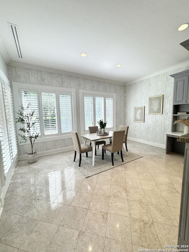 dining room with a wealth of natural light and ornamental molding