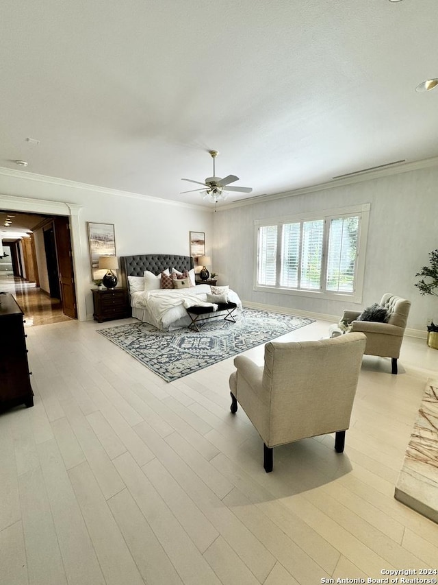 bedroom with ornamental molding, ceiling fan, and light hardwood / wood-style flooring