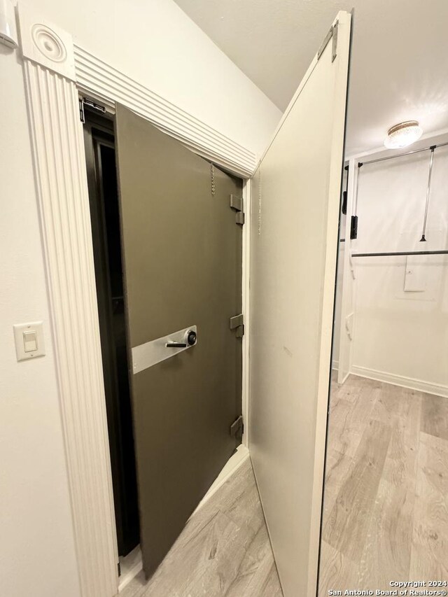 bathroom with hardwood / wood-style flooring