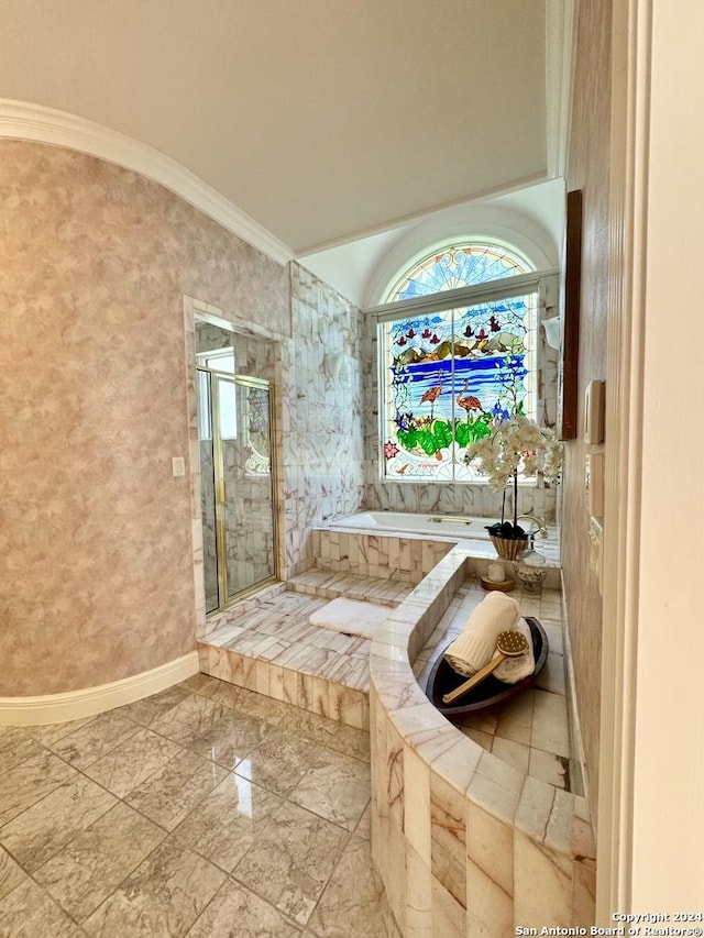 bathroom featuring ornamental molding, separate shower and tub, and vaulted ceiling