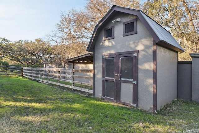 view of outbuilding featuring a yard