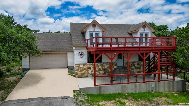 view of front facade featuring a garage and a wooden deck