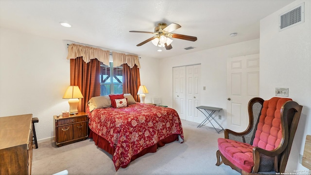 carpeted bedroom with ceiling fan and a closet