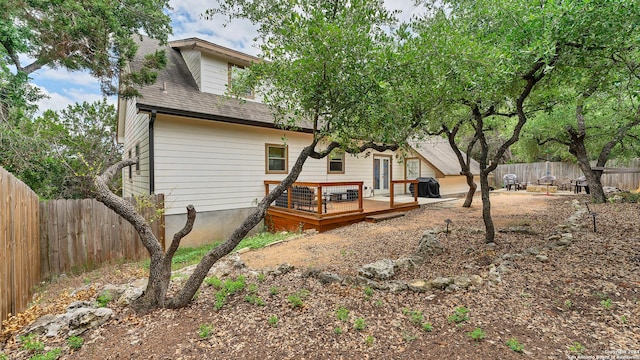 rear view of house featuring a deck