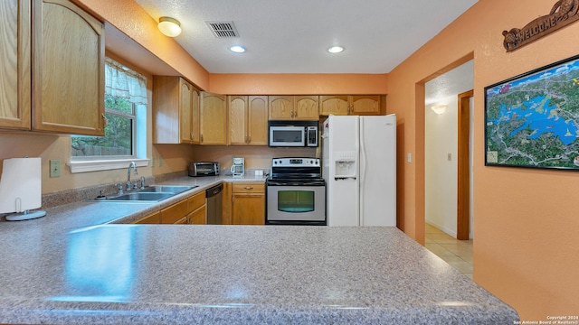 kitchen with kitchen peninsula, sink, and appliances with stainless steel finishes