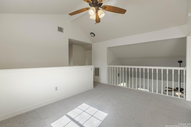 spare room with ceiling fan, vaulted ceiling with beams, and carpet floors