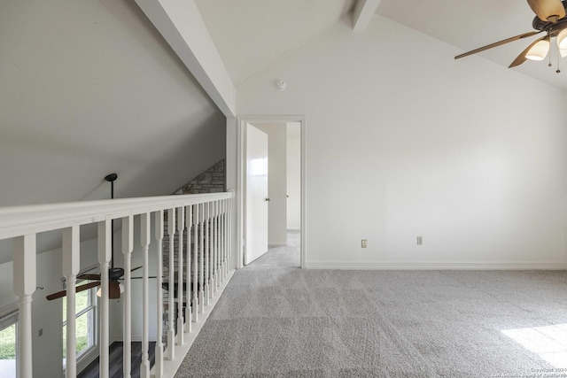 hall featuring vaulted ceiling with beams and carpet flooring