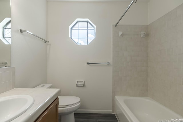 full bathroom with toilet, vanity, wood-type flooring, and tub / shower combination