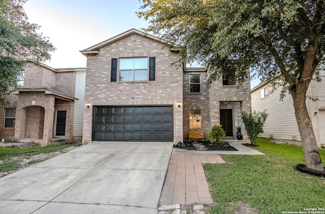 view of property with a front yard and a garage