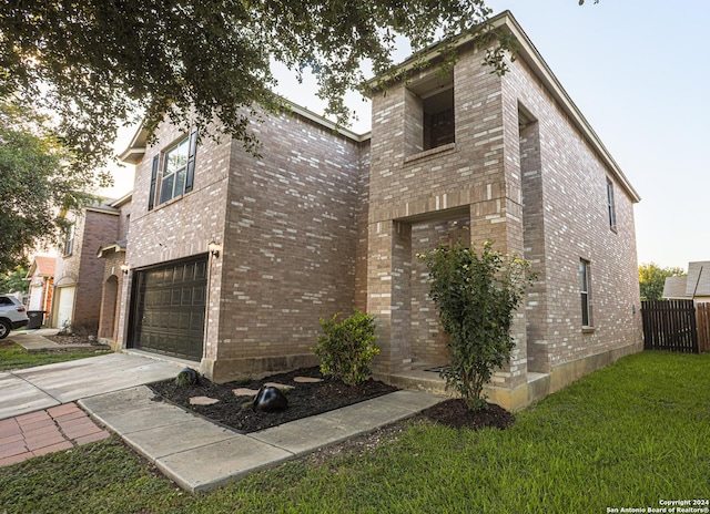 view of front of home with a front yard and a garage