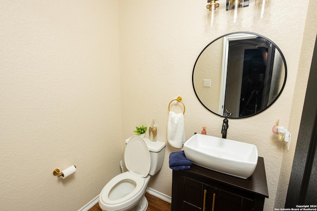 bathroom featuring vanity, hardwood / wood-style floors, and toilet