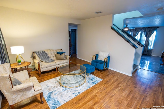 living room with ceiling fan and wood-type flooring