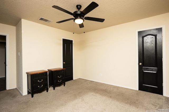 interior space featuring ceiling fan and a textured ceiling