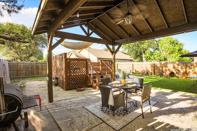 view of patio featuring a gazebo, grilling area, ceiling fan, and a wooden deck