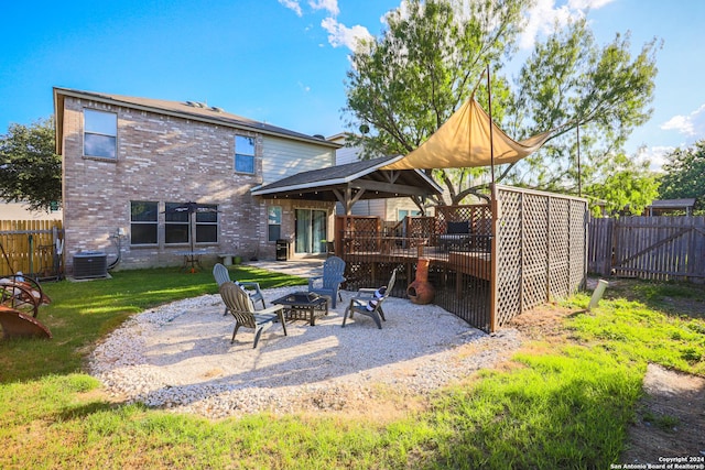 exterior space featuring central AC, a gazebo, a lawn, a fire pit, and a patio