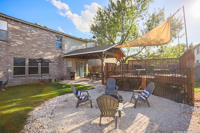 view of patio featuring a gazebo and a fire pit