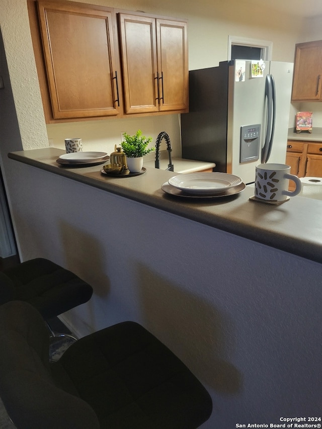 kitchen featuring stainless steel refrigerator with ice dispenser