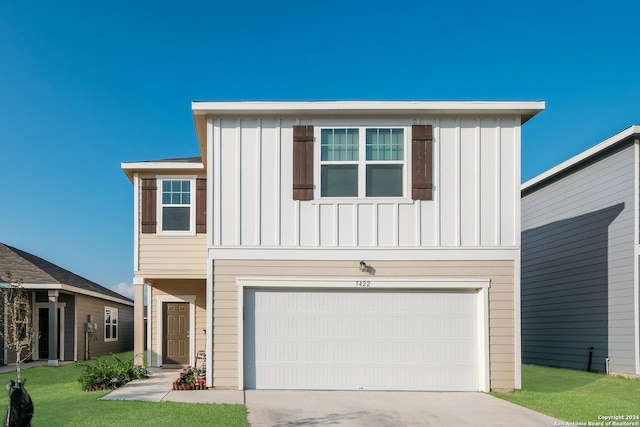 view of front facade with a front yard and a garage