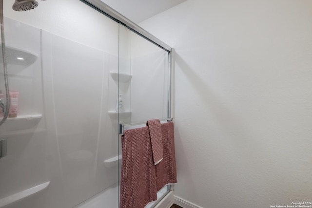 bathroom with a shower with shower door