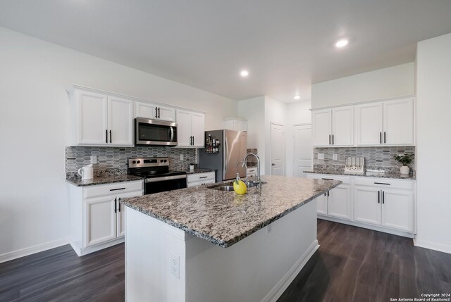 kitchen featuring white cabinetry, a kitchen island with sink, and appliances with stainless steel finishes