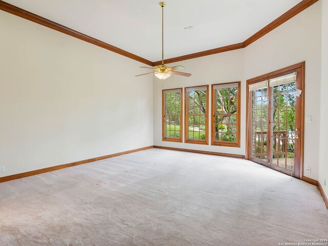 unfurnished room with carpet, ceiling fan, ornamental molding, and a towering ceiling