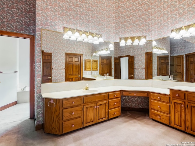 bathroom with a bathing tub, a high ceiling, and double sink vanity