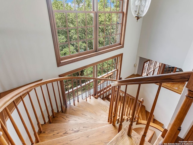 stairs featuring a notable chandelier and parquet flooring