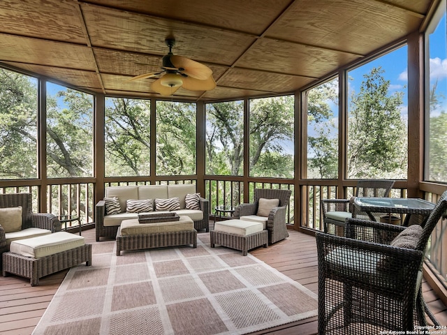 sunroom with wood ceiling, a wealth of natural light, and ceiling fan