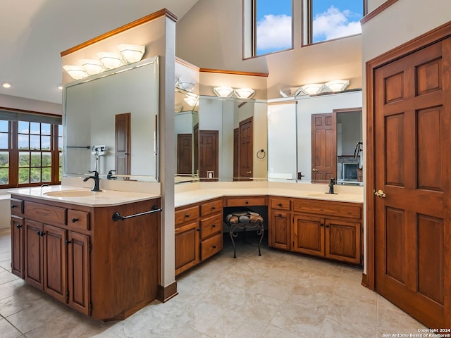 bathroom with tile patterned flooring, vanity, and a high ceiling