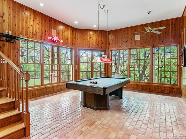 playroom featuring pool table, ceiling fan, and wood walls