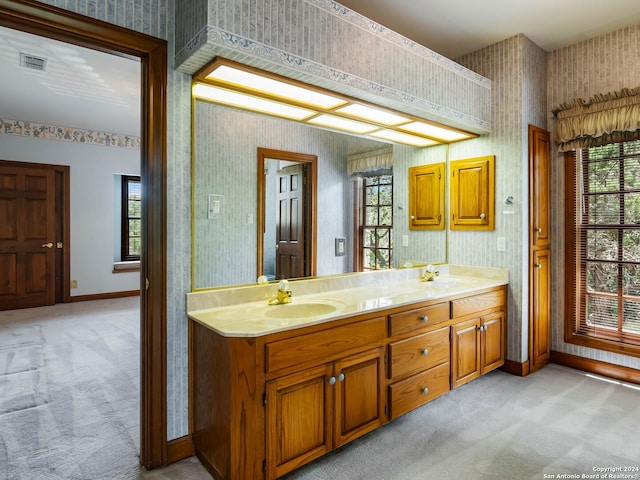 bathroom with a healthy amount of sunlight and dual vanity