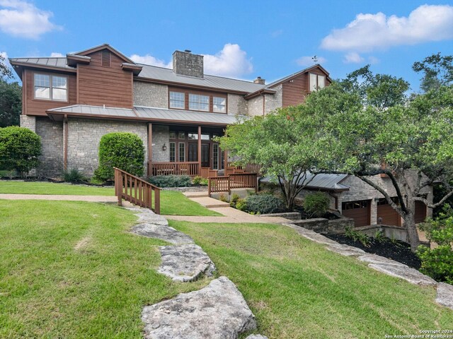 rear view of property featuring a lawn