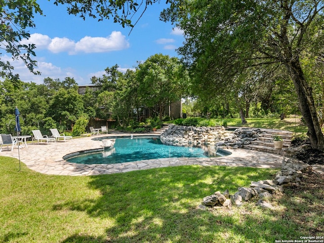 view of pool featuring a patio area and a lawn