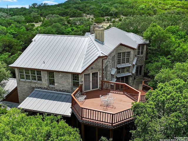 rear view of house with a wooden deck