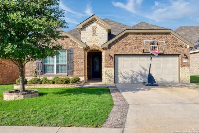 view of front of property with a front yard and a garage