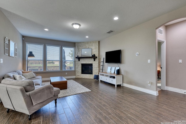 living room featuring a fireplace and a textured ceiling