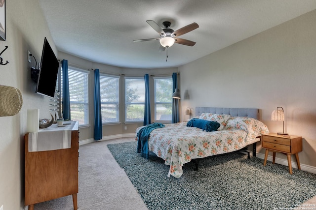 bedroom with ceiling fan and light colored carpet