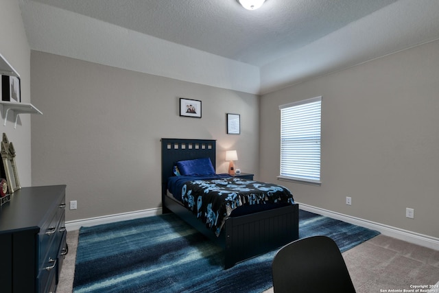 carpeted bedroom featuring a textured ceiling