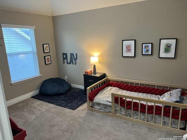 carpeted bedroom featuring lofted ceiling