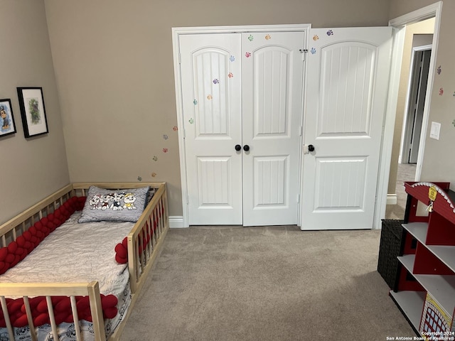 bedroom featuring light colored carpet and a closet