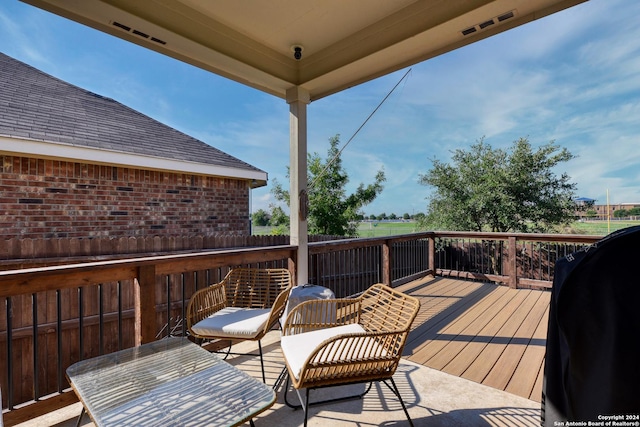 wooden terrace featuring grilling area