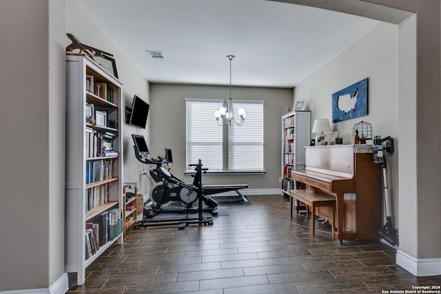 exercise area with a notable chandelier