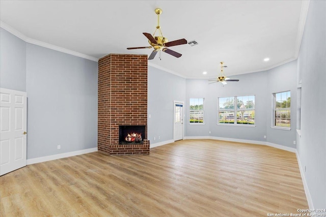 unfurnished living room with ceiling fan, ornamental molding, light hardwood / wood-style flooring, and a brick fireplace