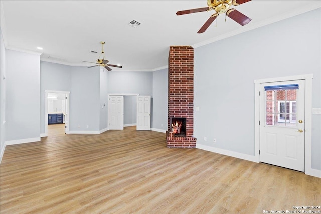 unfurnished living room with crown molding, a fireplace, ceiling fan, and light wood-type flooring